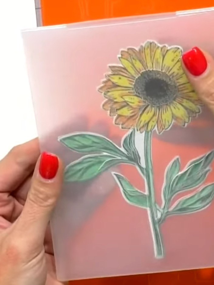 Passo 8: Place the die-cut sunflower design inside the 3D embossing folder, carefully lining it up with the raised patt