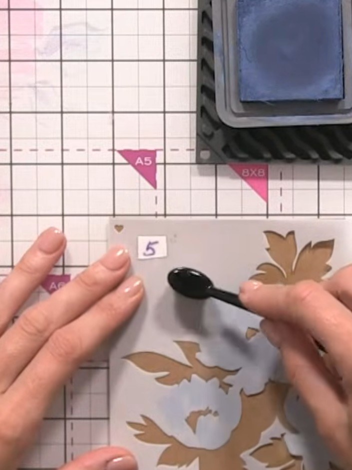 Step 9: Apply blue ink through stencil layers five and six to add colour variation to the leaves. Use a blending brush