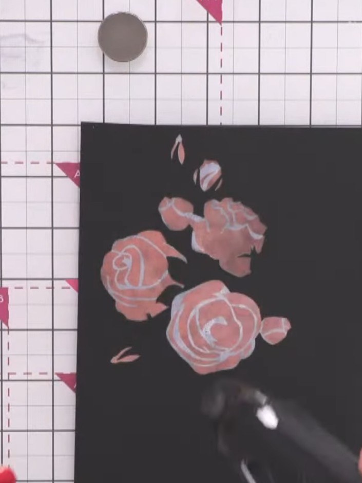 Passo 5: Position the third rose stencil layer over your design and apply a lighter shade of pink pigment ink using the
