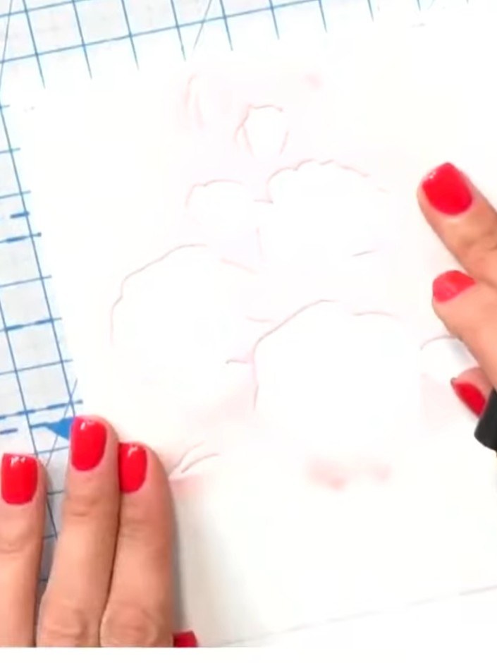 Passo 1: Place the stencil on your watercolour cardstock. Use a blending tool to apply ink through the stencil onto the