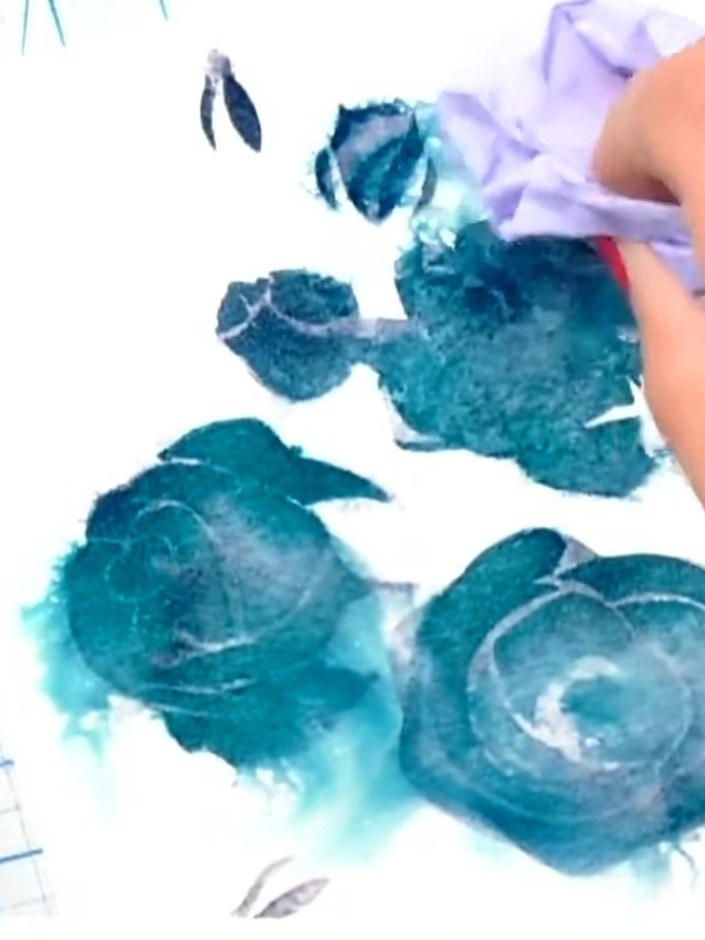 Passo 7: Place the third stencil (bluebells) over your design and apply a rich teal colour using a dauber or sponge, pr