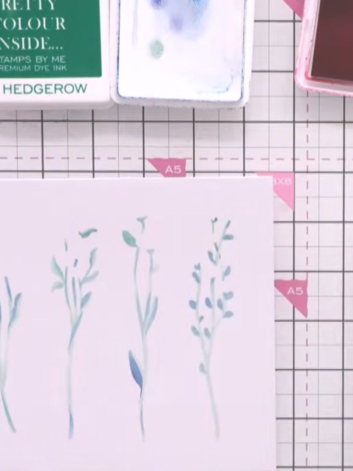 Step 6: Using the vase layering stencils, position the first stencil over your card and apply teal ink through the ste