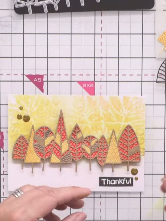 Stap 10: Add gold enamel dots around the card as final embellishments. Place them randomly across the yellow starburst 