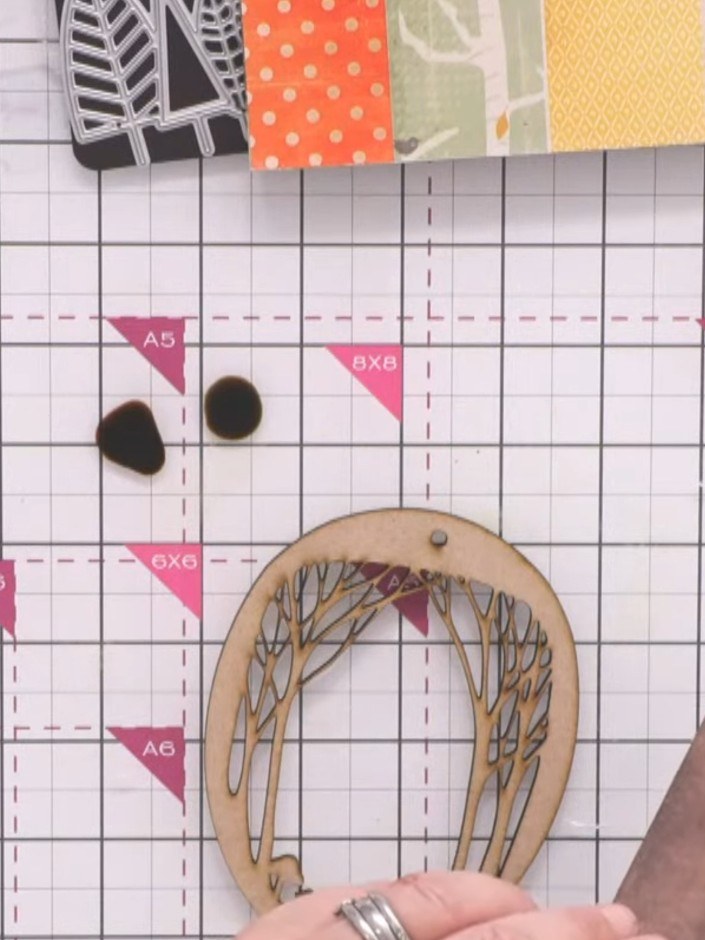 Step 7: Layer the stained MDF wreath overlay on top of the stained heart-shaped MDF base piece, aligning them together