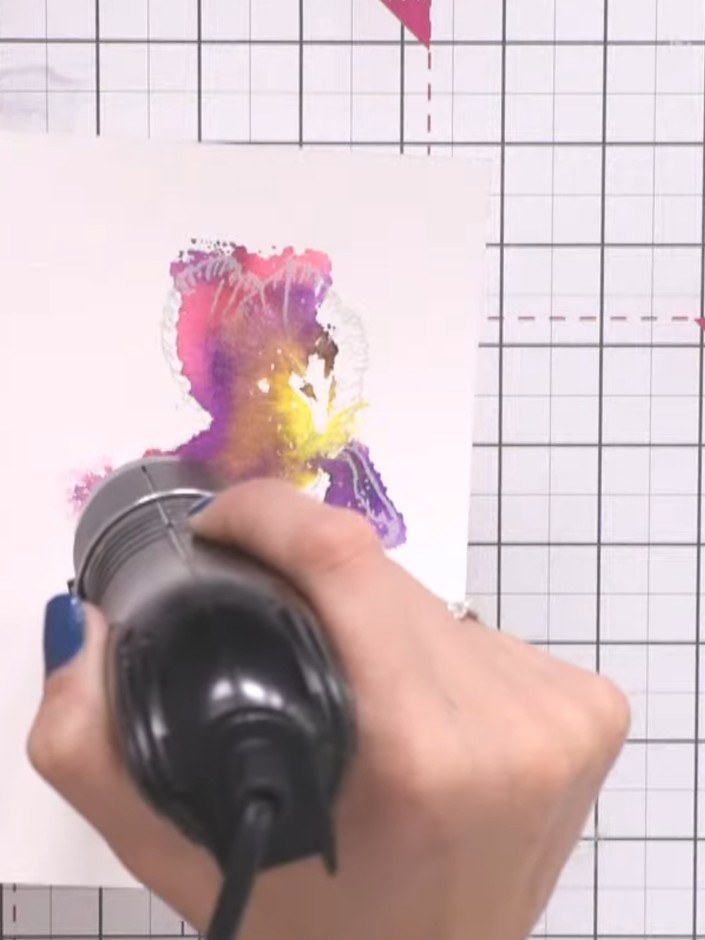 Stap 10: Heat the sticky bonding powder with a heat gun, moving it over the entire flower design until the powder becom