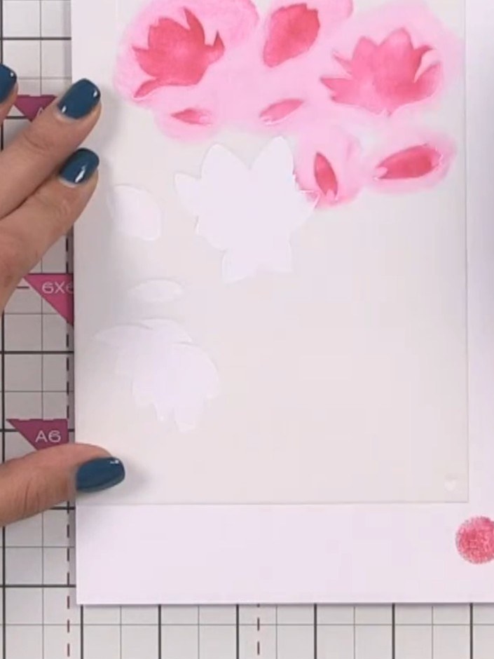 Passo 2: Apply pink ink through the floral stencil using a mini cube ink pad, building up bright, bold coverage with a 