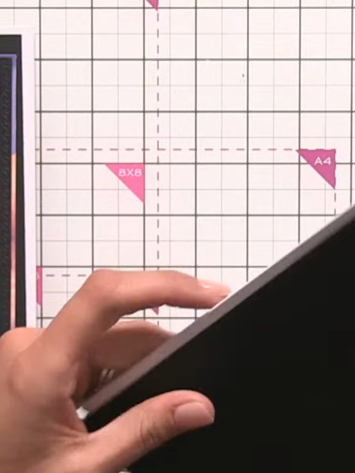 Step 1: Trim black card stock to create a card base. Score and fold the card to form the base structure.