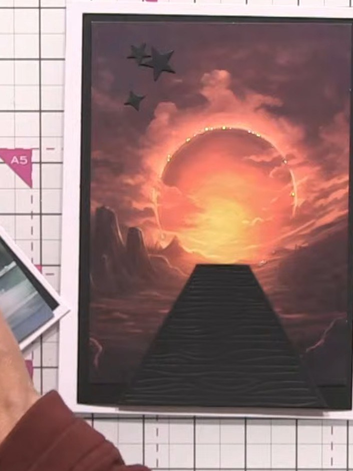 Step 8: Apply glitter glue around the sun area on the sunset scene to add sparkle and highlight the focal point.