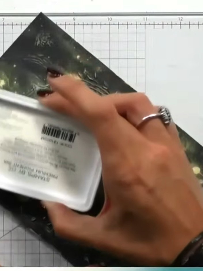 Step 5: Apply white ink over the embossed fairy design using an ink pad, working the ink into the raised areas. The wh