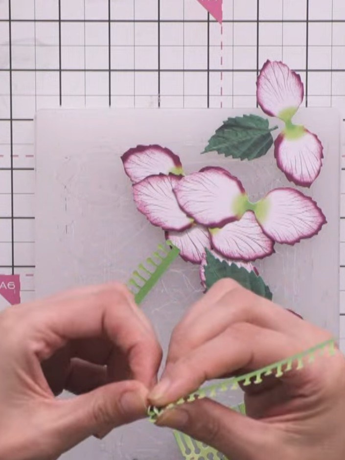 Step 5: Layer the three flower sizes together, starting with the largest at the bottom, then the medium, and finally t