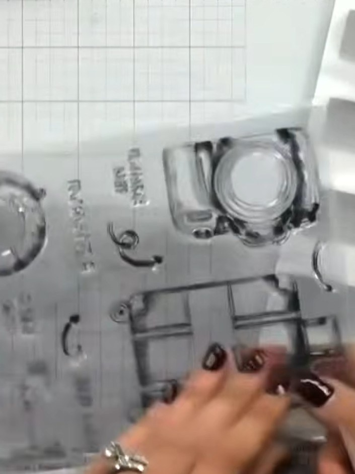 Step 1: Stamp the aperture images from the A5 stamp set onto your card base. Include the suitcase, camera, globe, and 
