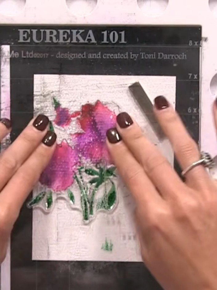 Step 5: Spray the inked stamp two or three times with water from a spray bottle to allow the pink and purple colours t