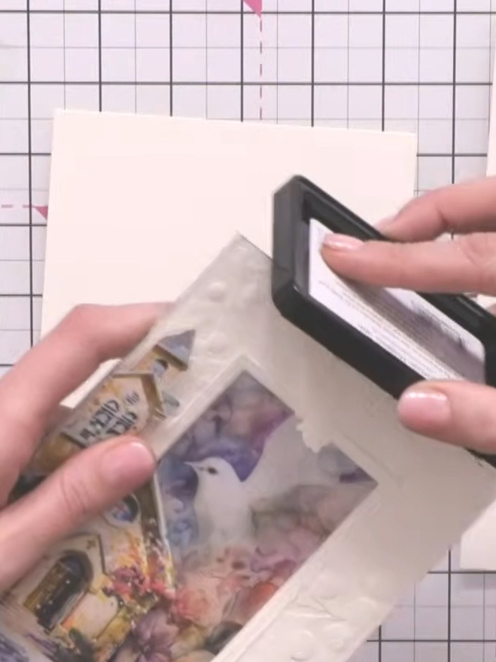 Step 6: Edge the embossed panel with black ink using an ink pad, angling it along the raised edges of the embossing to