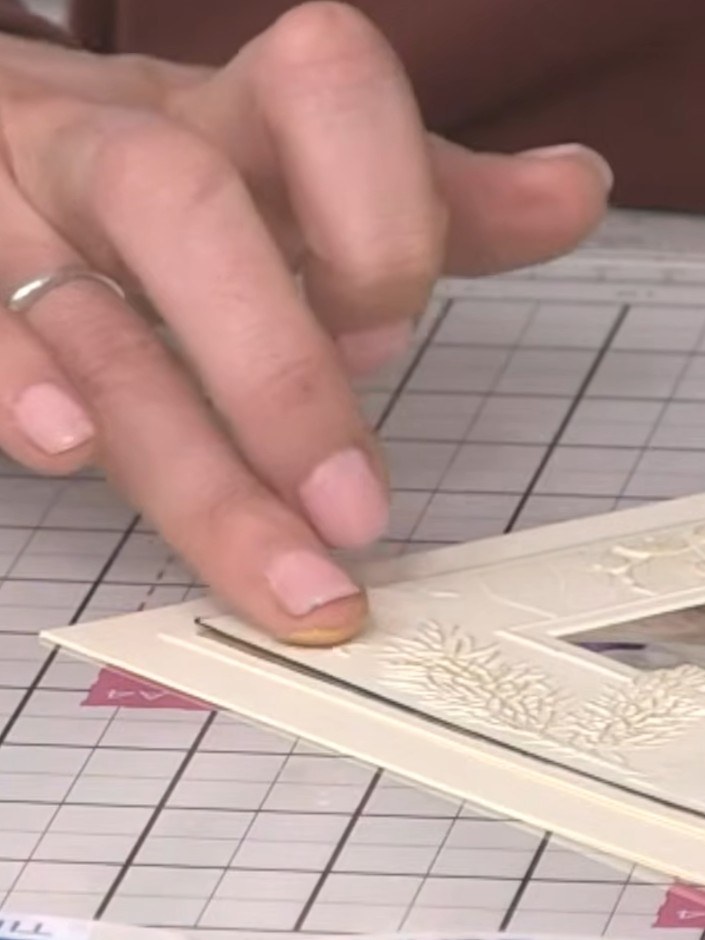 Step 8: Apply gold blending wax to your finger and gently rub it onto select details of the watercolour church design 