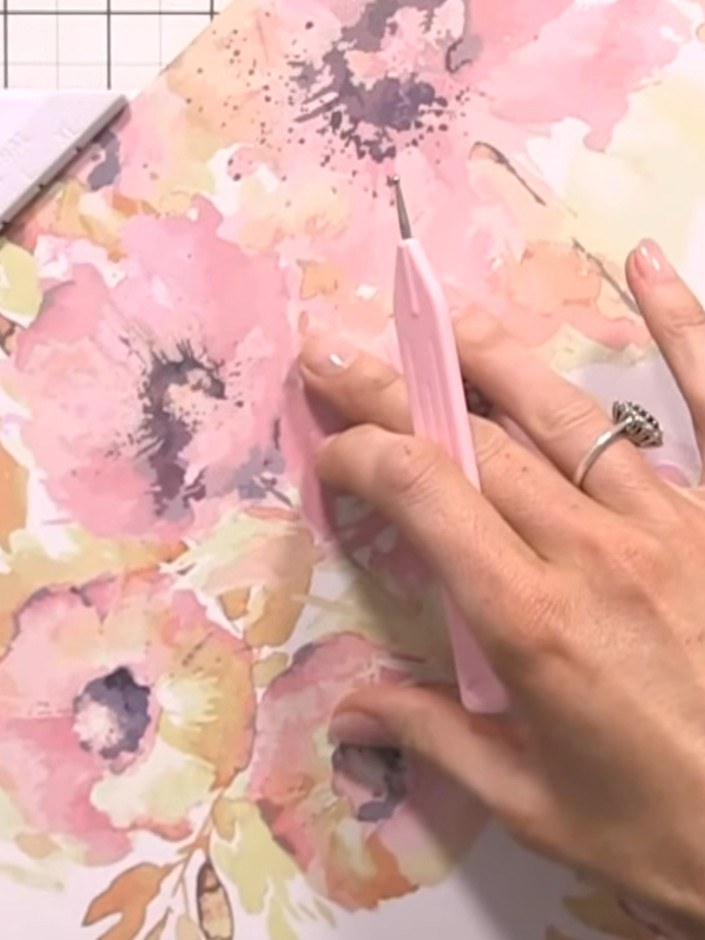 Step 2: Score down the first line on your patterned paper. Then use the XL punch to create holes along the marked line