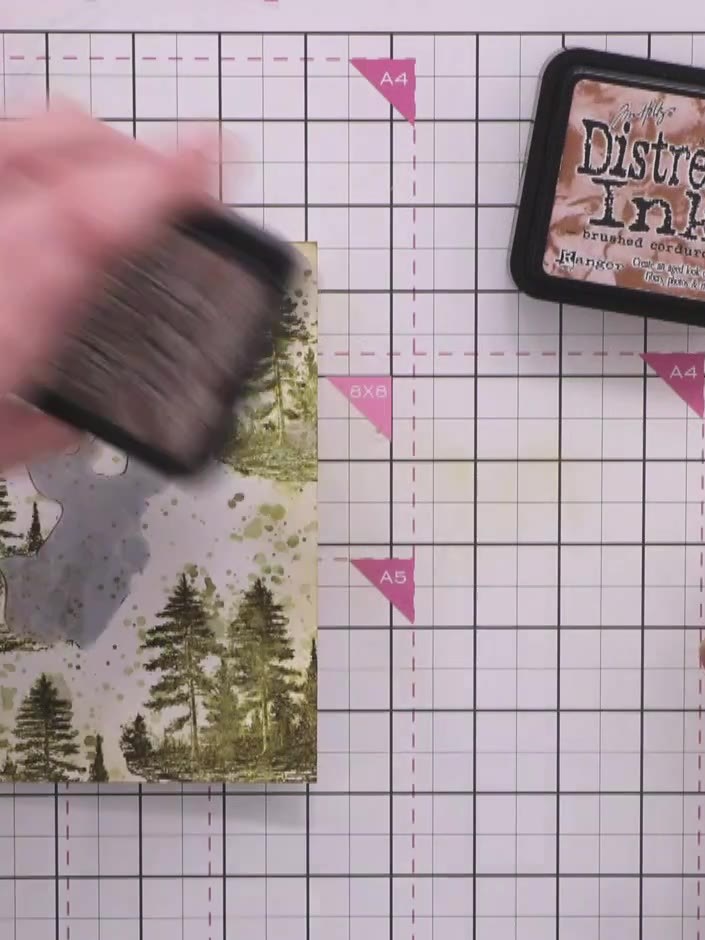 Step 10: Apply a darker brown ink closer to the edges of the card. Finish by adding a light wash of black ink around th