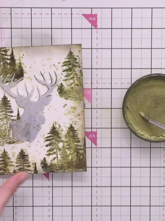 Step 11: Using a paintbrush, apply gold ink from the pot to add touches of shimmer around the card, catching the light 