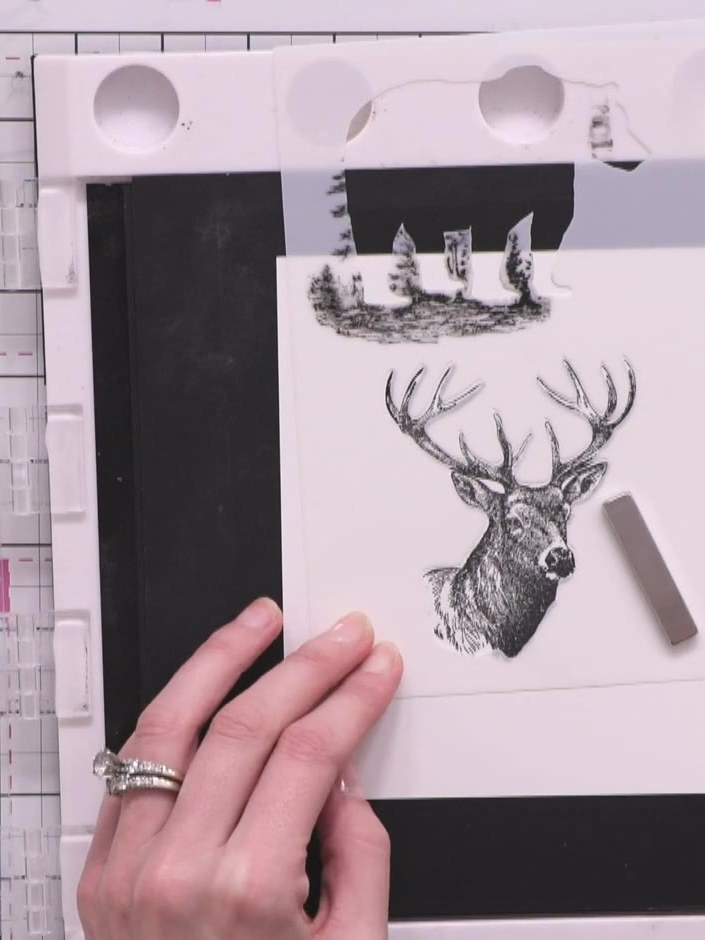 Step 2: Position the interior stencil over the stamped stag image. Colour in the stag using brown distress inks (Fraye