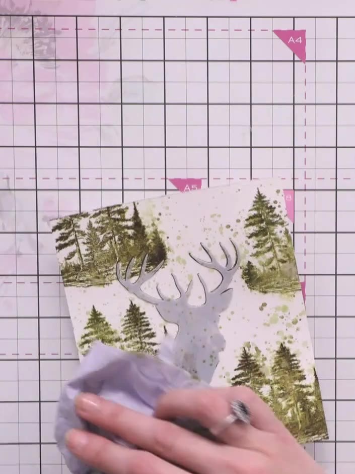 Step 8: Carefully peel away and remove the mask to reveal the protected white stag silhouette underneath the stamped a