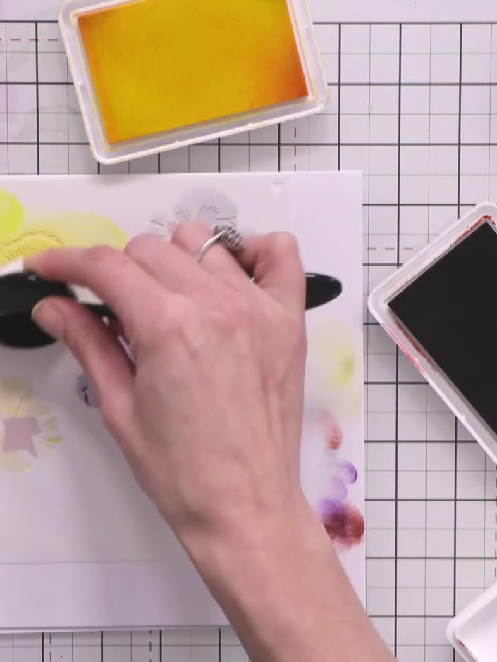 Step 6: Apply stencil number four over the card to complete the first pansy formation. Repeat the entire stenciling pr