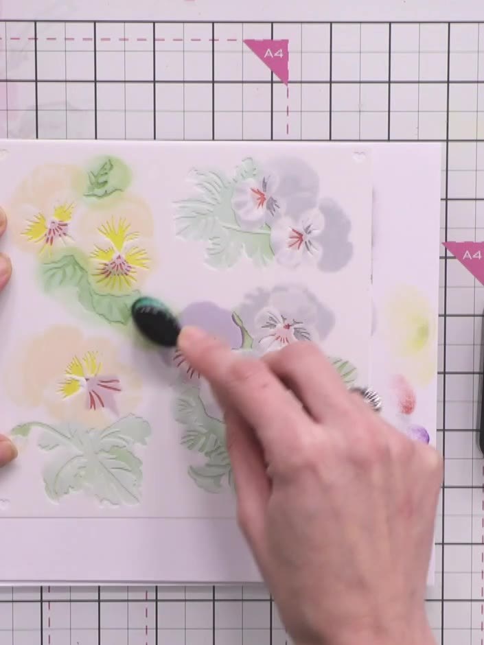 Step 8: Apply stencil number six to add darker green to the leaf edges and centres of the flowers using Distress Ink i