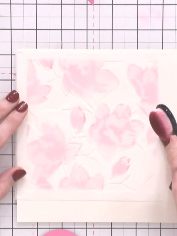 Step 4: Position the third stencil over your card and apply pink ink to create the background floral elements. Use a b