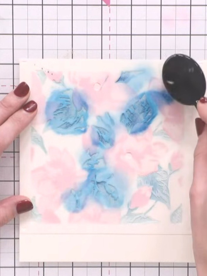 Step 5: Position the fourth stencil over your card and apply purple ink using a blending tool to add the final details