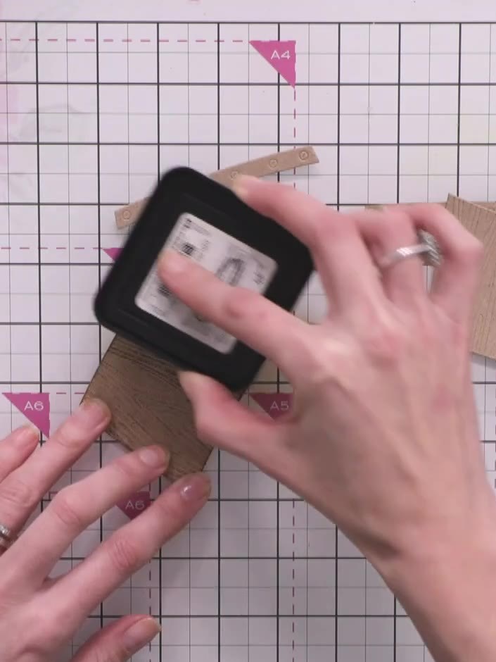 Step 1: Swipe a brown ink pad directly across the embossed wooden crate pieces to create a rustic, distressed appearan