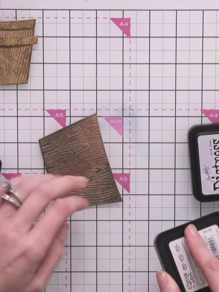 Step 3: Apply grey and blue Distress Ink pads to a second wooden crate piece to create a seashore or driftwood effect.