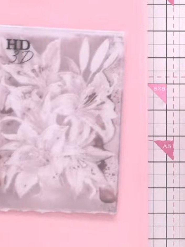 Step 5: Carefully lift away the pink card from the embossing folder to reveal the embossed tiger lily design with the 
