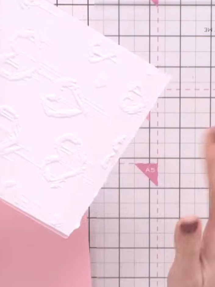 Step 2: Spray the inked embossing folder lightly with water to create a watercolour effect.