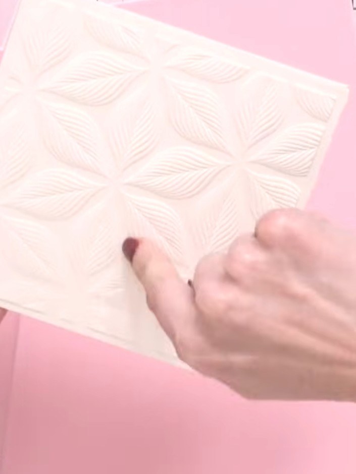 Step 2: Carefully cut around the embossed leaf and flower shapes with scissors to separate them from the background ca