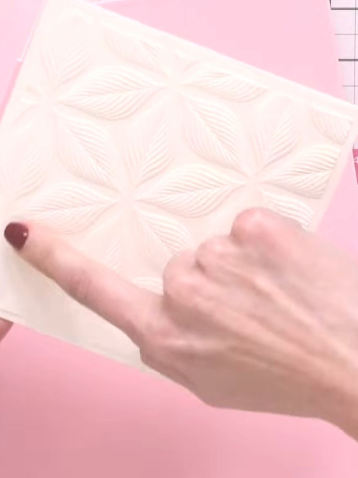 Step 3: Shape and layer the cut pieces to create a dimensional 3D flower effect on your card. Arrange the embossed geo