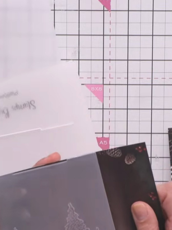 Step 1: Run your patterned paper through the embossing folder to create the raised village design with trees and pine 