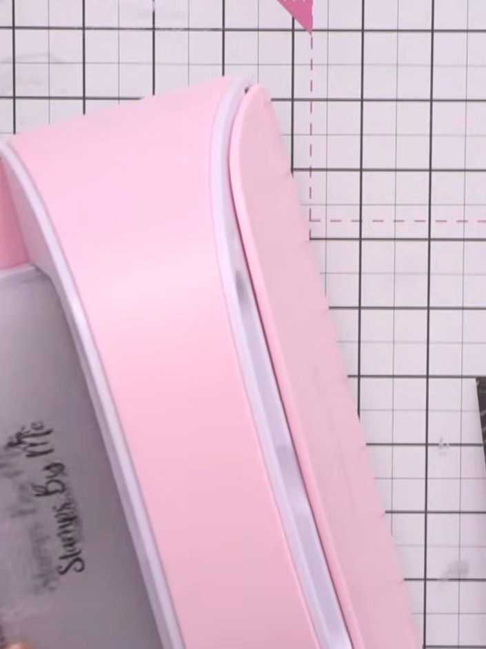 Step 2: Using your die-cutting machine or trimmer, trim down the embossed winter village piece to remove any ragged ed