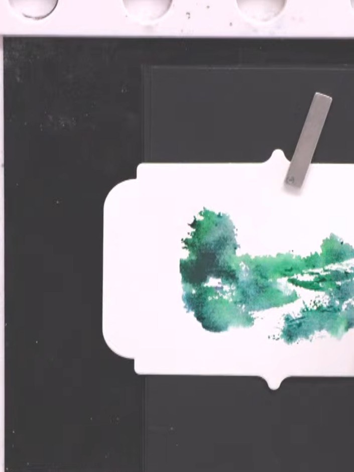 Step 7: Clean the stamp thoroughly and allow the watercoloured landscape card to dry completely before proceeding to t