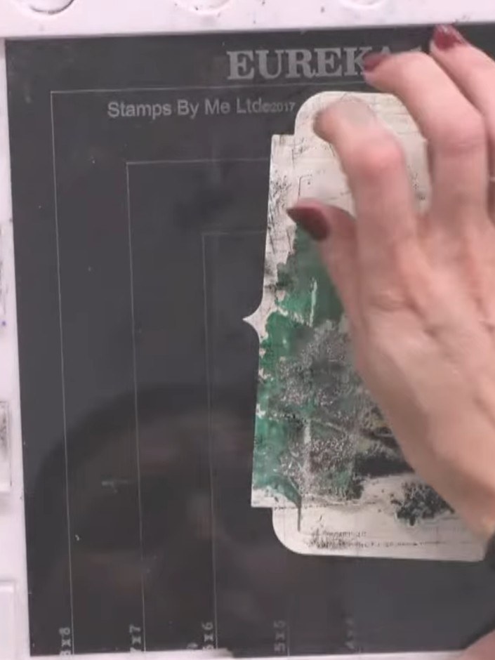 Step 10: Using a damp brush, gently blend water over the stamped scene to soften edges and create watercolour effects. 