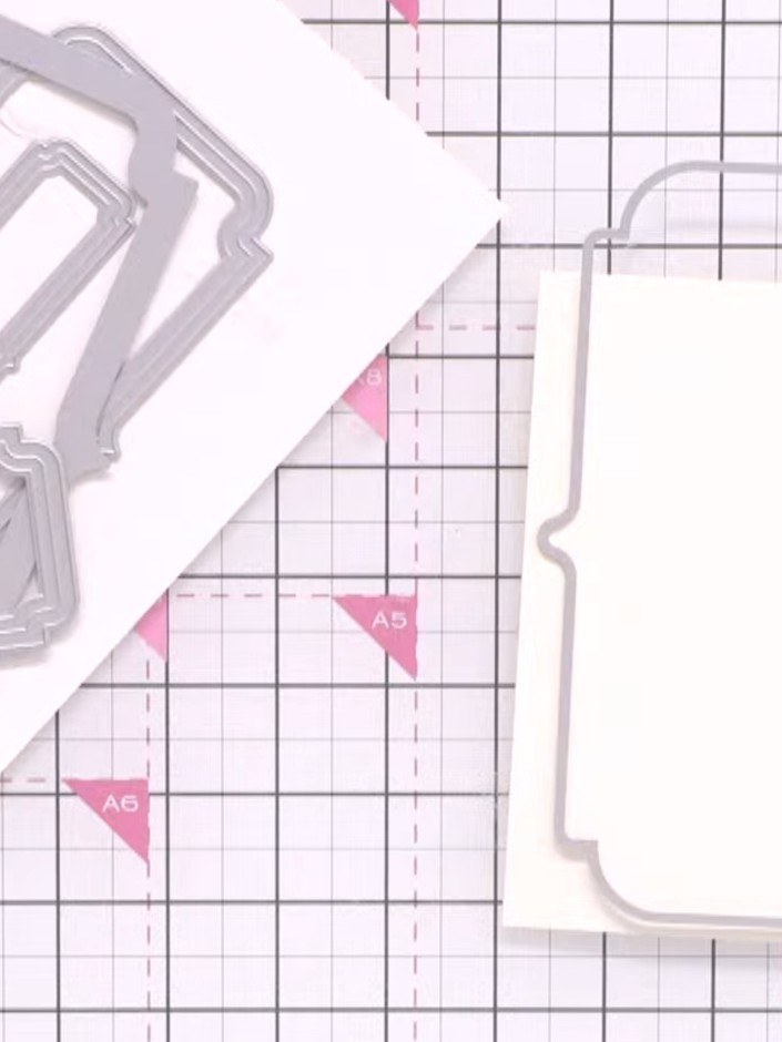 Step 3: Place the shaped border die onto your white card base. Run the die and card through your die-cutting machine t