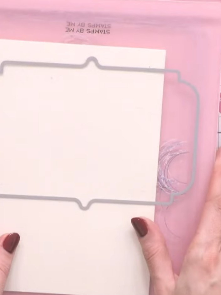 Step 4: Carefully pop out the die-cut frame shape from the cream card panel. The frame has a decorative border edge an