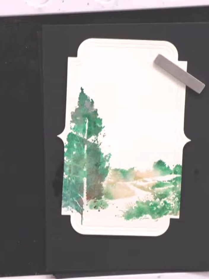 Step 9: Use the tree detail stamp with black ink to add definition to the foliage. Stamp small birds onto the scene to