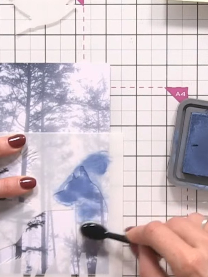 Step 2: Position the mask over the wolf area on your stencilled paper. Using a blending brush, apply blue ink around t