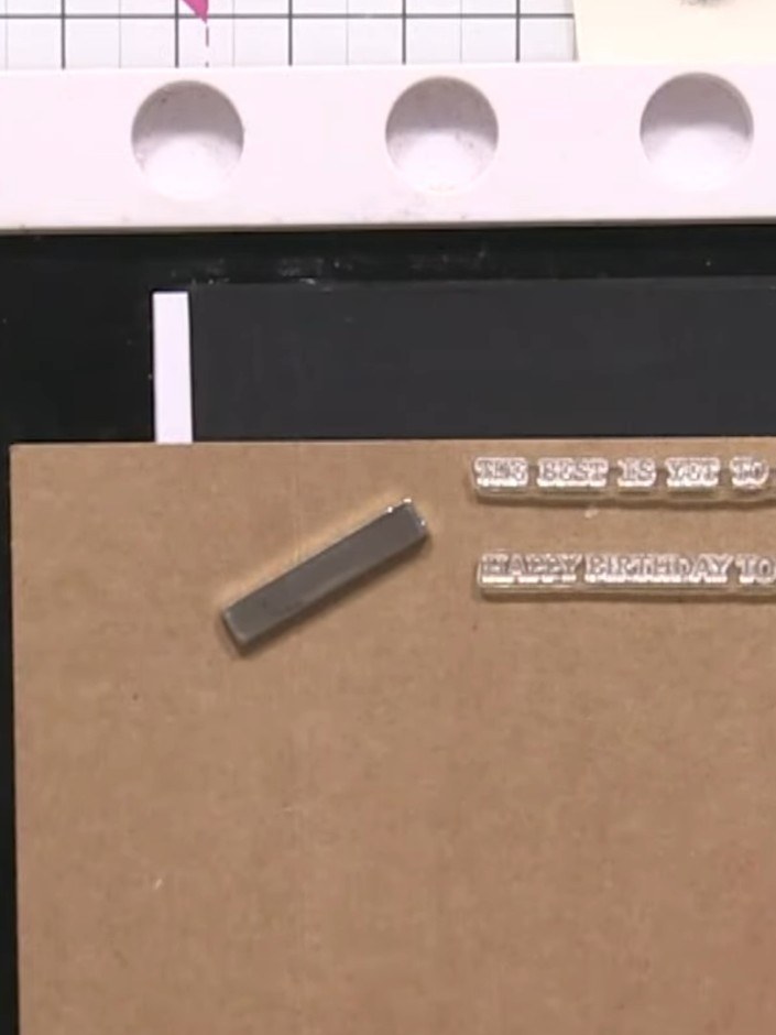 Step 7: Trim the sentiment strips to size. Adhere one sentiment strip flat to the card front and attach the second str