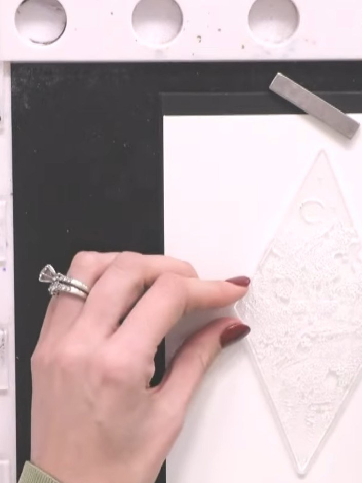 Step 1: Place a large diamond-shaped waste-free die into your die-cutting machine with a piece of white watercolour ca