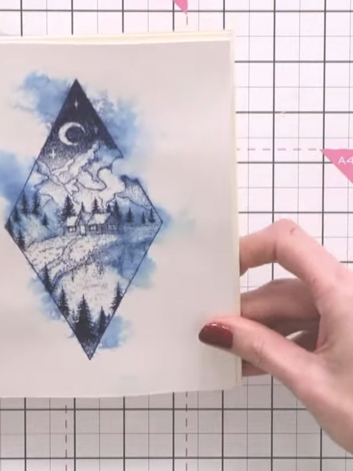 Step 10: Layer the diamond aperture frame on top of the card using foam pads for dimension. Alternatively, adhere it fl