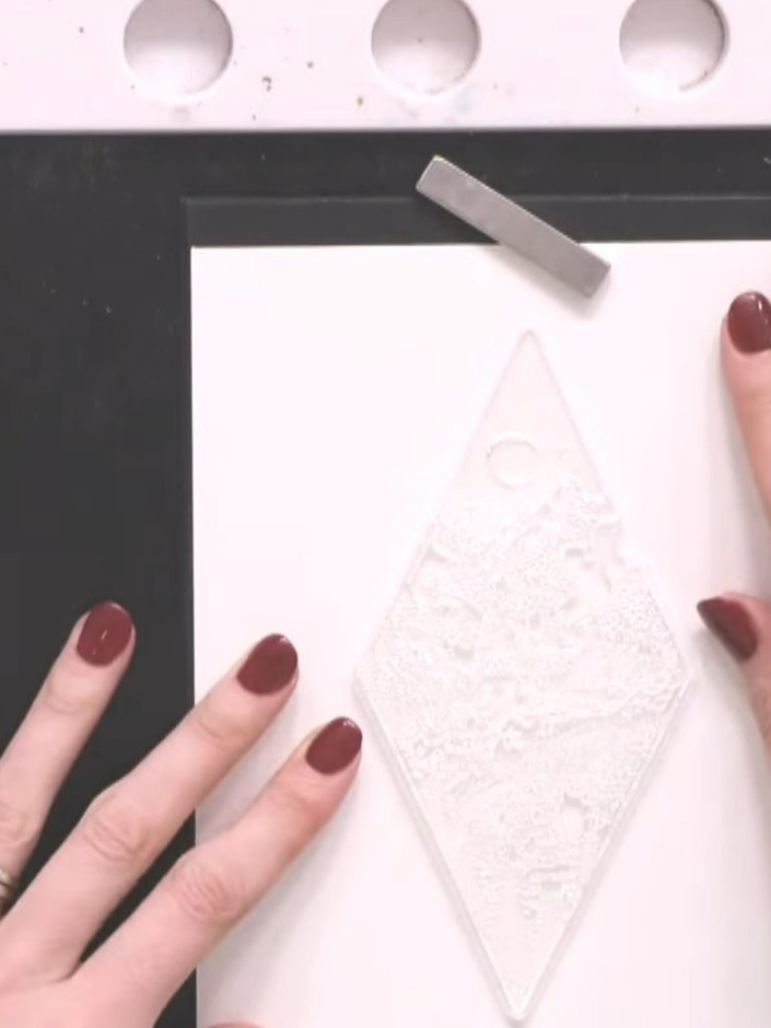 Step 2: Lightly tap the ocean-coloured premium ink pad onto your diamond stamp, using minimal ink to create a subtle e