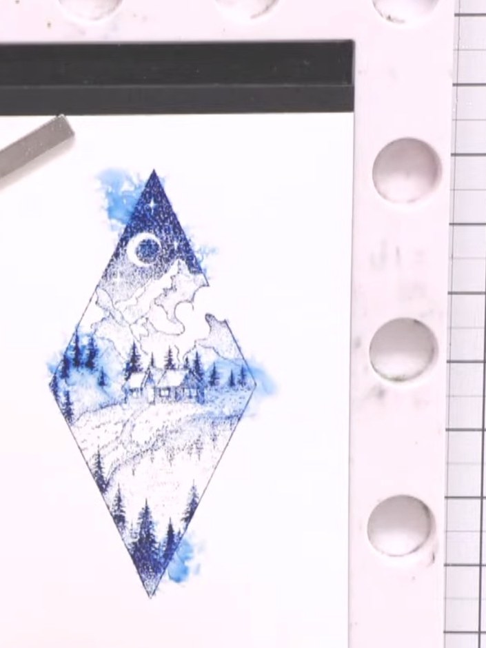 Step 4: Spray the stamped design lightly with water using a water mister, allowing the blue ink to bleed and blend out