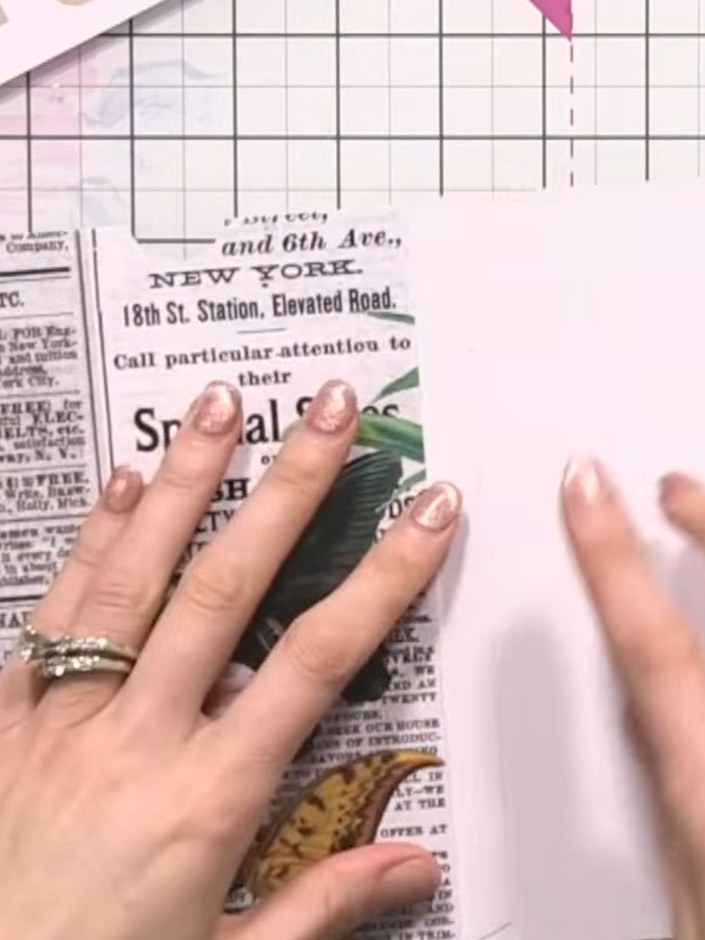 Step 5: Position and glue the decorative pocket piece onto the album page, aligning it to create an interactive fold-o