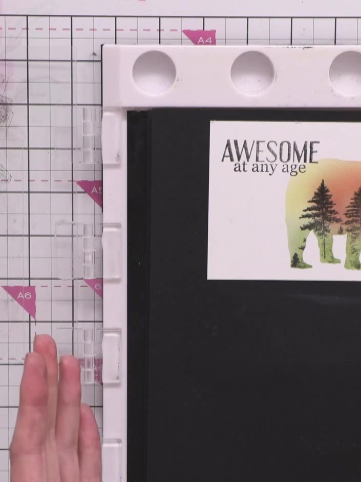 Step 11: Stamp the sentiment 'AWESOME at any age' above the bear using the Midnight black hybrid ink. Position the text