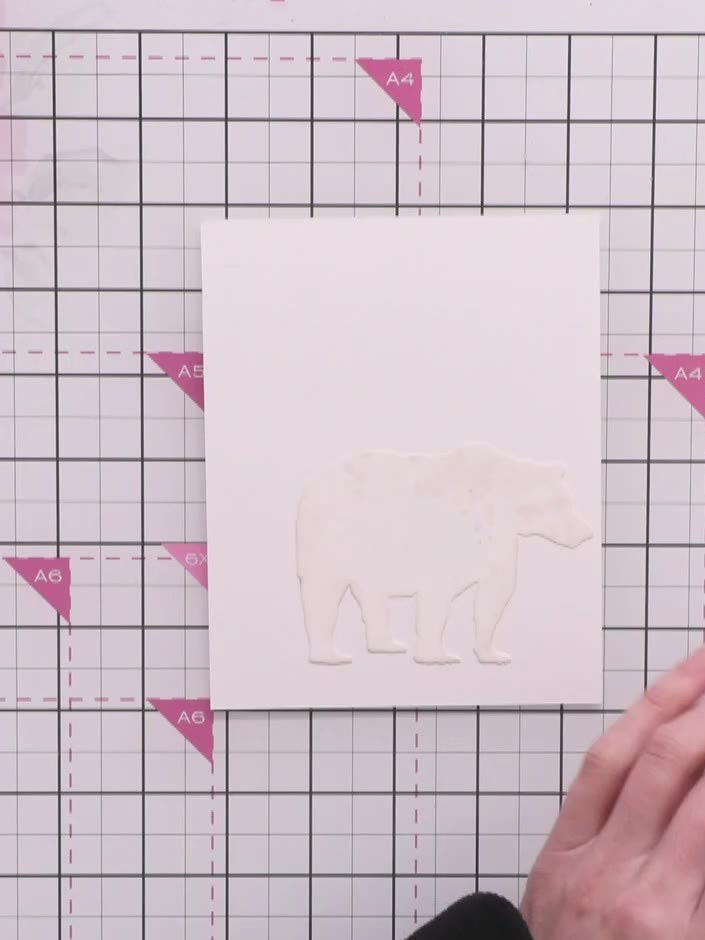 Step 2: Position the bear stamp off to one side of your card base on the magnetic glass mat. Place the Distress Ink pa