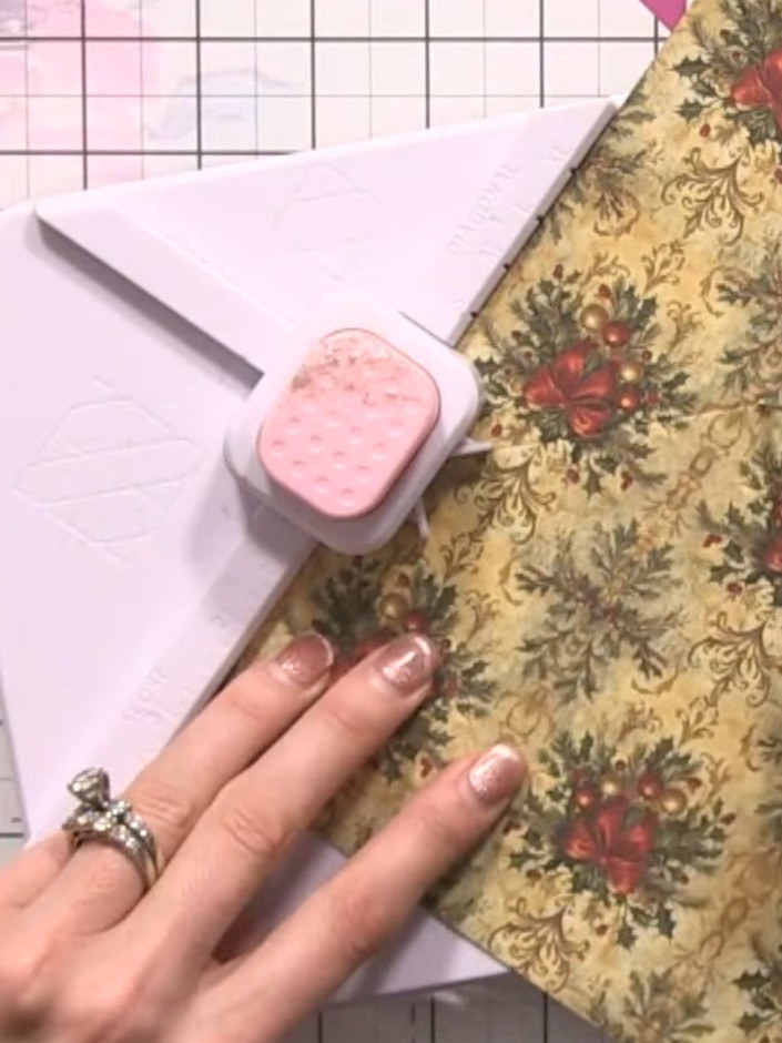 Step 5: Continue scoring along all four XL lines on the box and envelope maker, rotating the patterned card after each